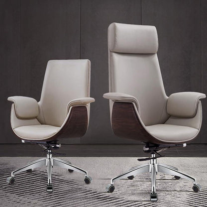 Two modern high-back office chairs with light beige leather upholstery and dark wood-grain side panels, shown on a patterned rug against a dark gray paneled wall.