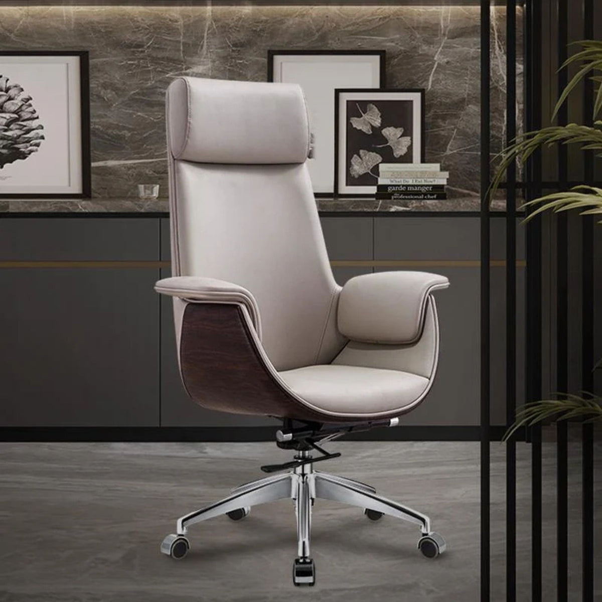 A modern high-back office chair upholstered in light beige leather with dark brown wood side panels and a chrome five-star base, shown in a styled office setting.