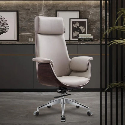 A modern high-back office chair upholstered in light beige leather with dark brown wood side panels and a chrome five-star base, shown in a styled office setting.